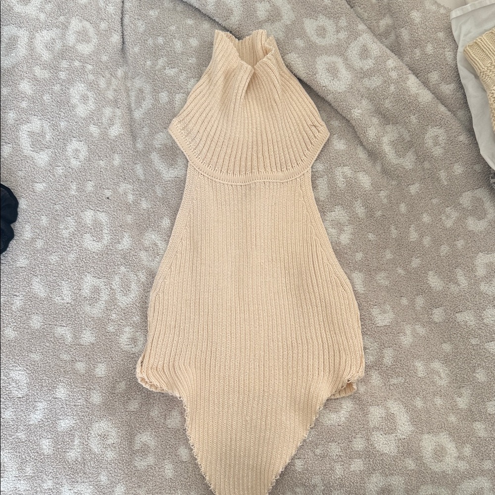 Beige Ribbed turtleneck cropped sweater. top folds down